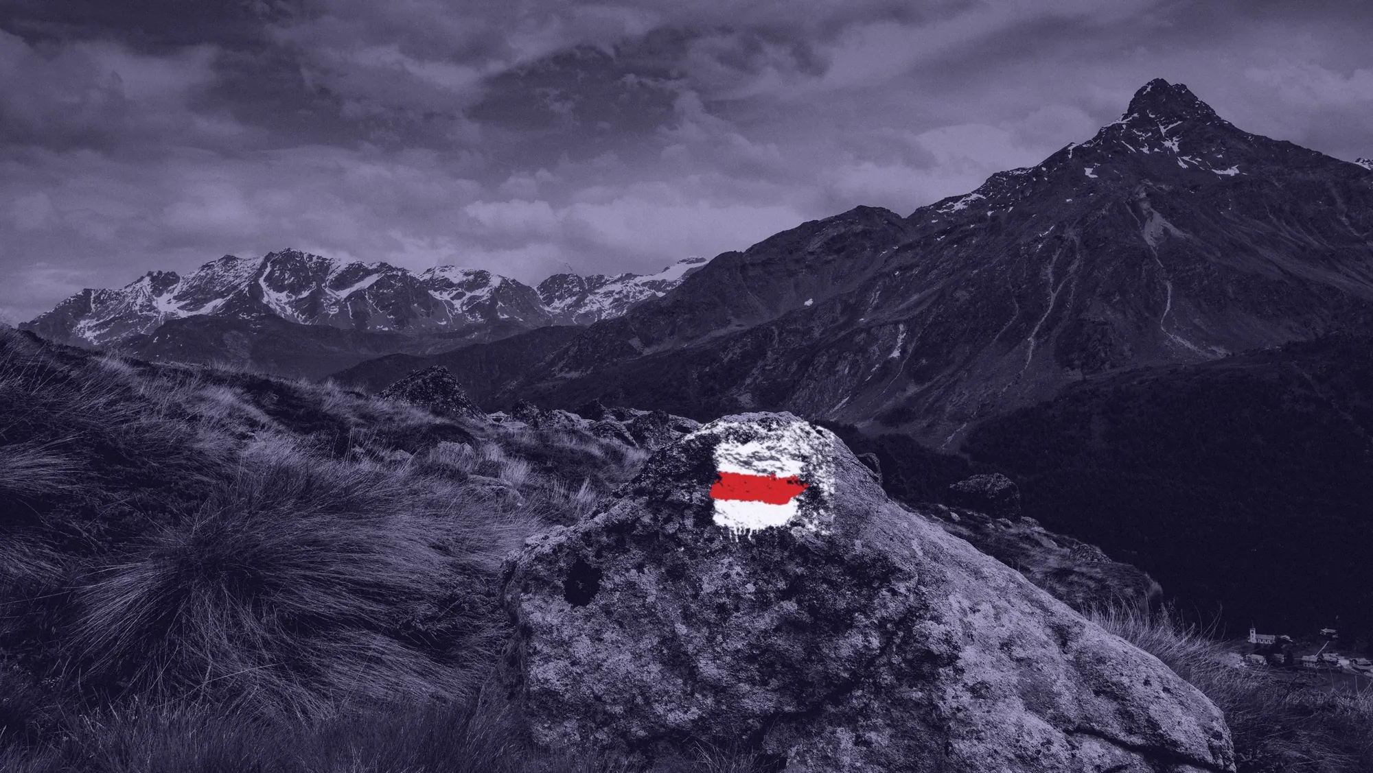 A white-red-white trail waymark painted on a rock above Scanfs, in duotone